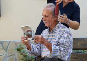 personal care assistance, elderly man getting his hair cut