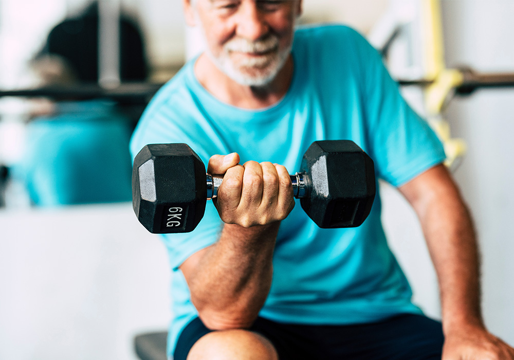 exercise and aging, older man curling a dumbbell